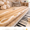 A beige plush sofa cover with gray stripes and a decorative flower cushion on a white sofa.