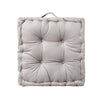 A square, light gray quilted cotton throw pillow with a fabric loop for sofa or floor seating.