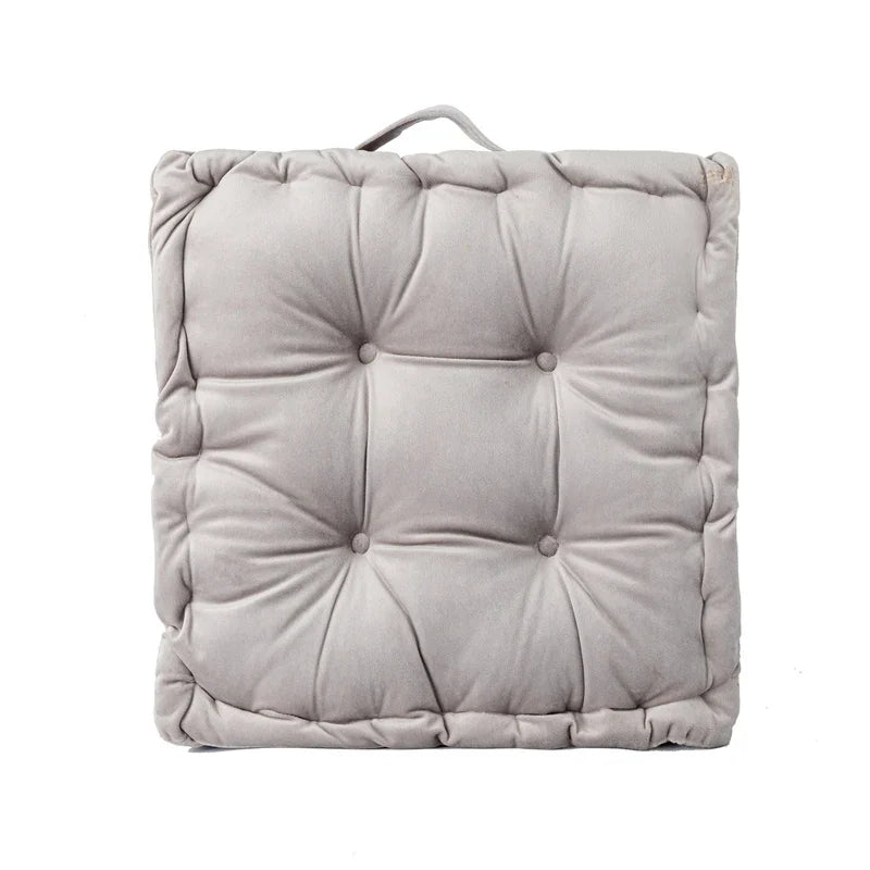 A square, light gray quilted cotton throw pillow with a fabric loop for sofa or floor seating.