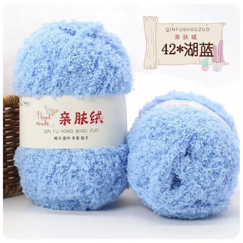 A ball of soft blue fuzzy yarn labeled as Plant Made coral velvet yarn for crafting.
