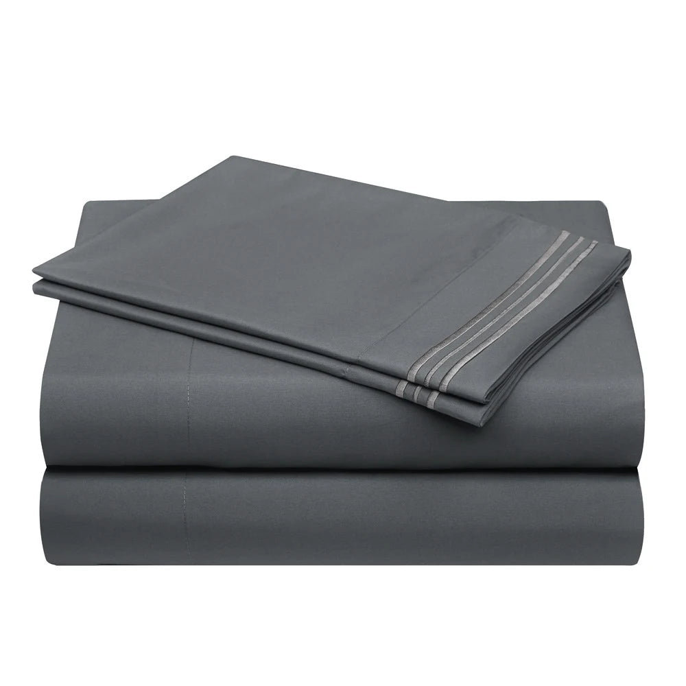 A stack of four gray microfiber bed sheets folded neatly, showing a striped detail on the top sheet.