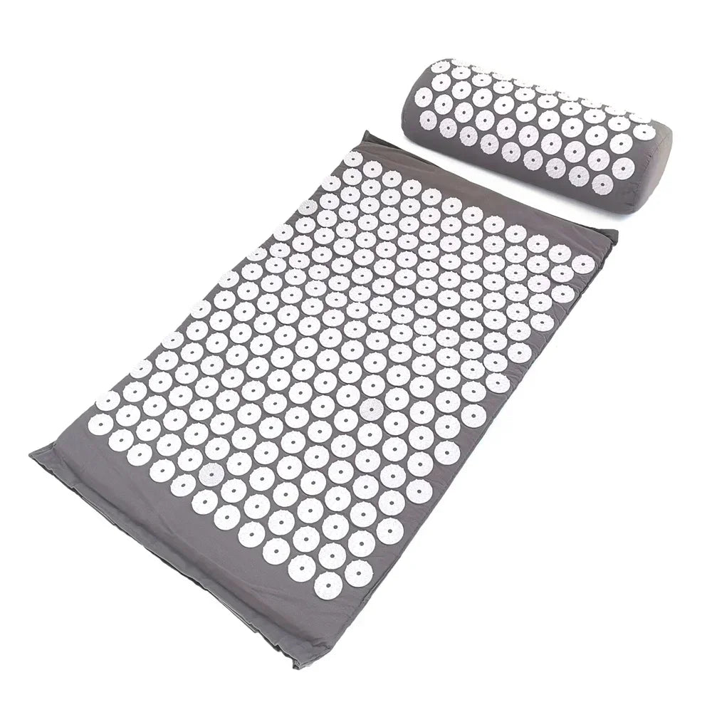 A gray acupressure relief mat and pillow set with numerous white acupressure points.