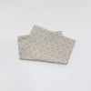 A folded soft cotton baby pillow cover with a geometric pattern on a white background.