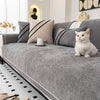 A gray chenille sofa protector cover is displayed on a sofa with striped pillows and a white cat.