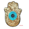 A gold sequin iron-on patch shaped like a hand with a blue eye design.