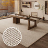 A woven faux sisal runner rug placed on a wooden table in a bright interior setting.