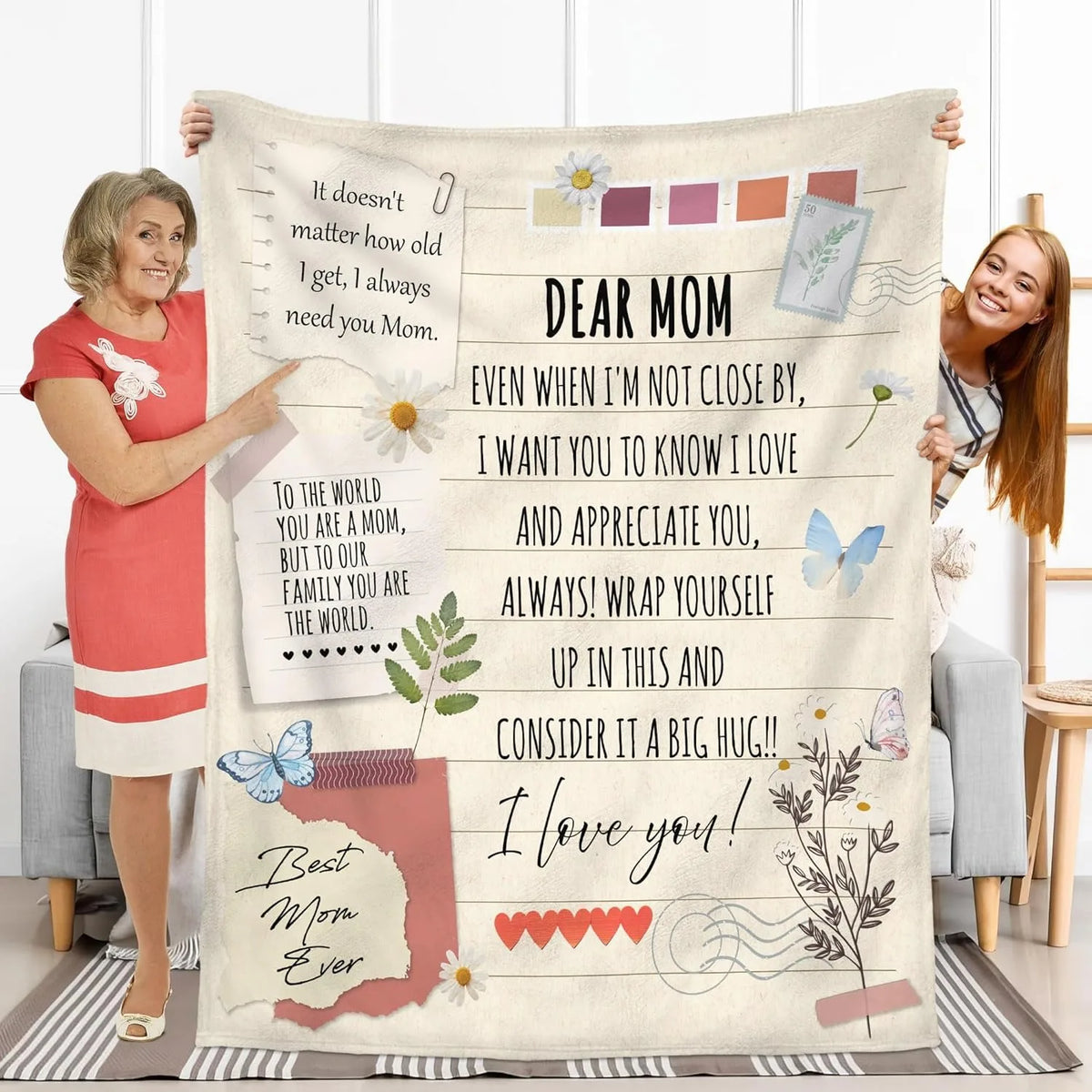 A soft printed throw blanket featuring inspirational text and floral designs, displayed on a couch.