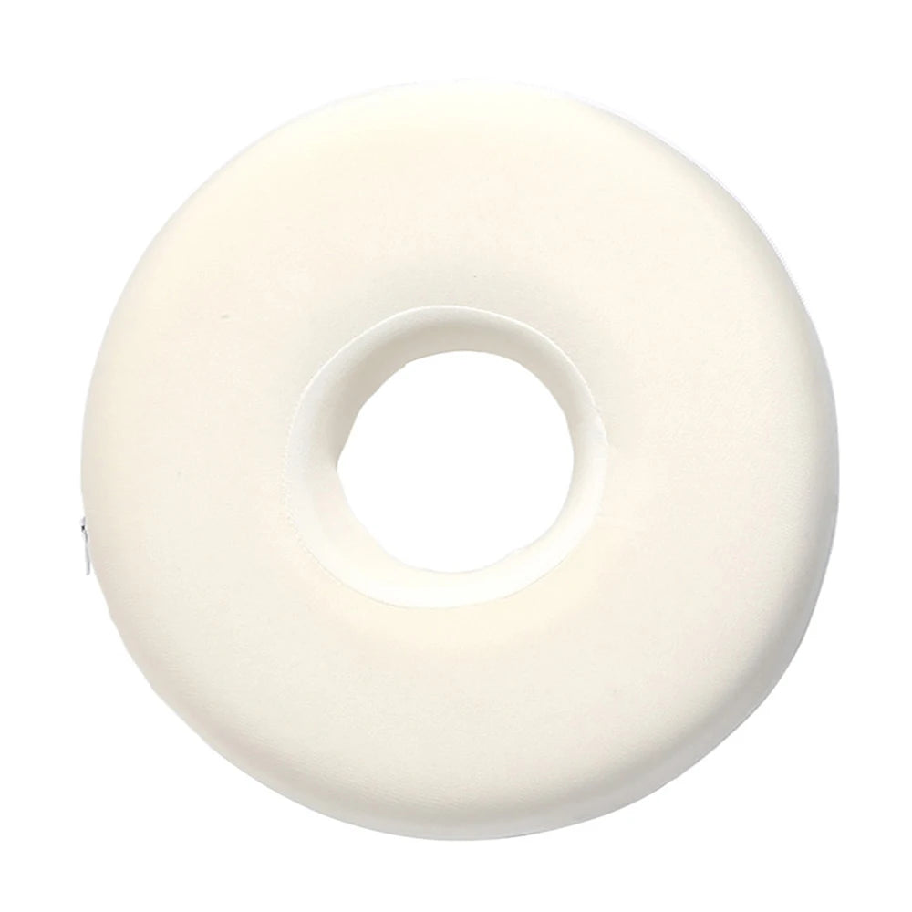 A white, circular ear piercing pillow designed for sleeping.