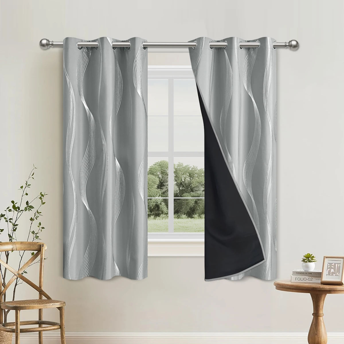 Elegant blackout curtains with a gray and black wave pattern hanging in a window.