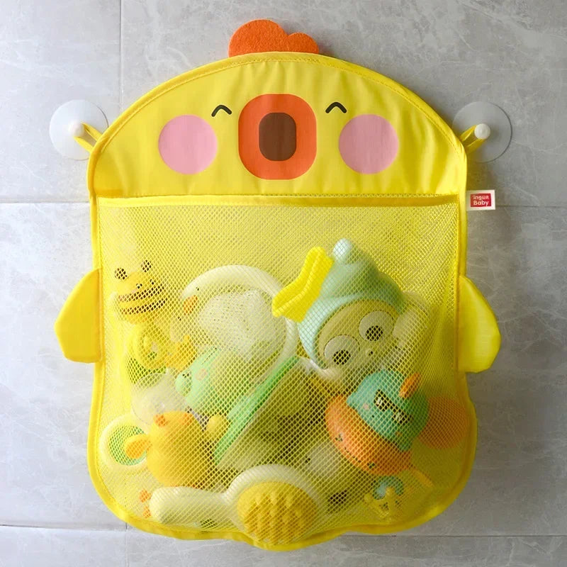 A yellow organizer bag with a face design holds various colorful bath toys and sponges.