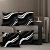 A set of black and white geometric pattern decorative pillowcases displayed on a sofa.