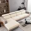 A light beige jacquard knit sofa cushion cover on a modern sectional sofa in a living room setting.