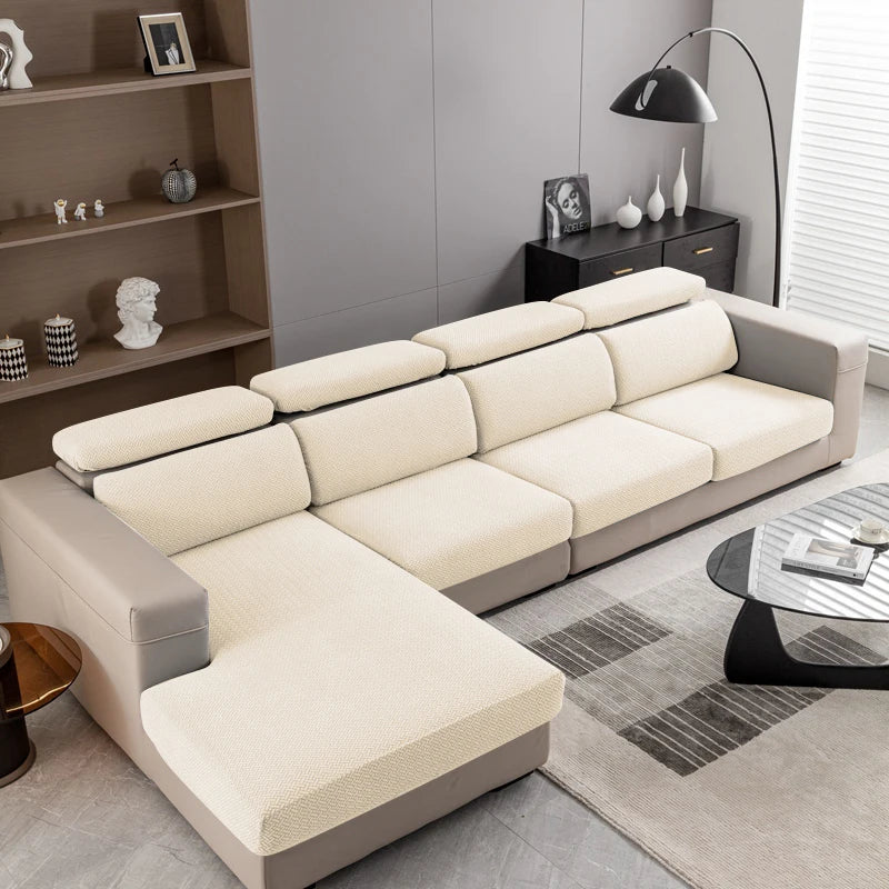 A light beige jacquard knit sofa cushion cover on a modern sectional sofa in a living room setting.