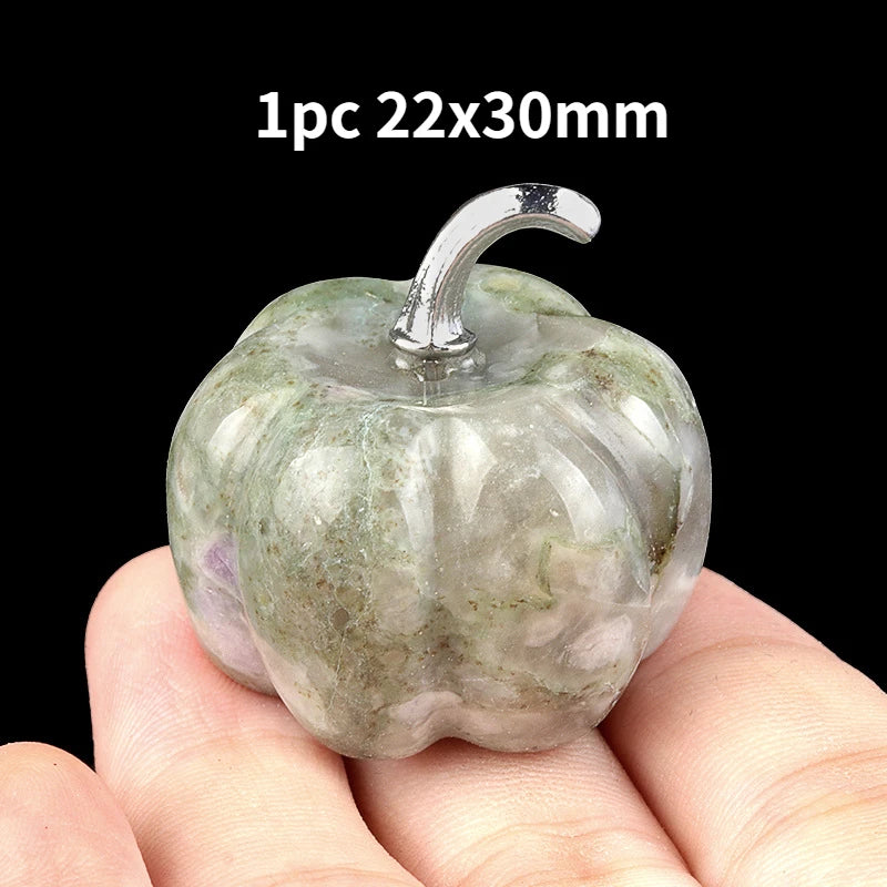 A hand holds a natural stone pumpkin figurine with a stem, measuring 22x30mm.