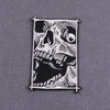 Black embroidered skull patch with white detailing on a fabric backing