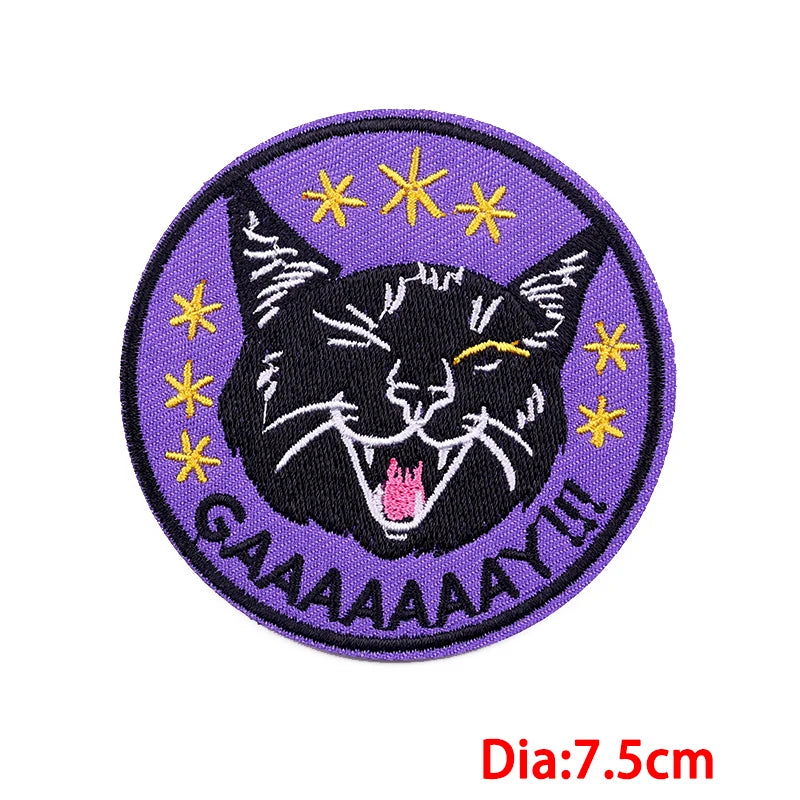 Purple embroidered patch featuring a black cat face with yellow stars and the text GAAAAAAAY!!!