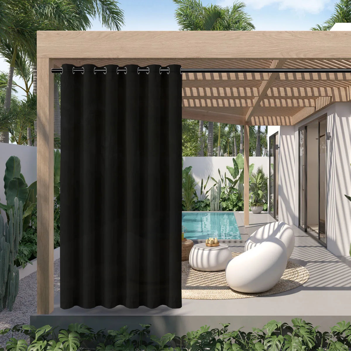 A black waterproof outdoor curtain with a grommet top hanging in a wooden pergola setting.