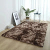 A dark brown thick silk wool area rug placed on a light wood floor in a bright room.