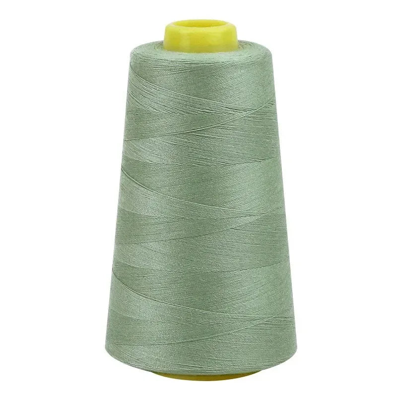 A roll of light green sewing thread with a yellow core.