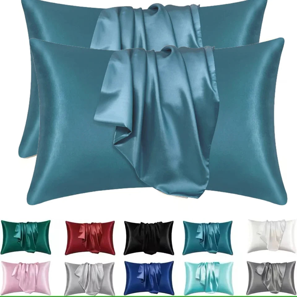 A collection of satin silk pillow covers in various shades including teal, blue, green, pink, and gray.