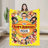 A yellow throw blanket featuring a graphic of characters from The Bob's Burgers movie poster.