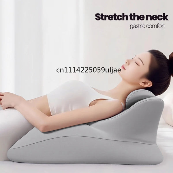 A woman is relaxing with an ergonomic memory foam wedge pillow for gastric comfort, demonstrating a neck stretch.