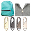 A set of zipper pull replacements in gold, black, and silver metal for bags and garments.