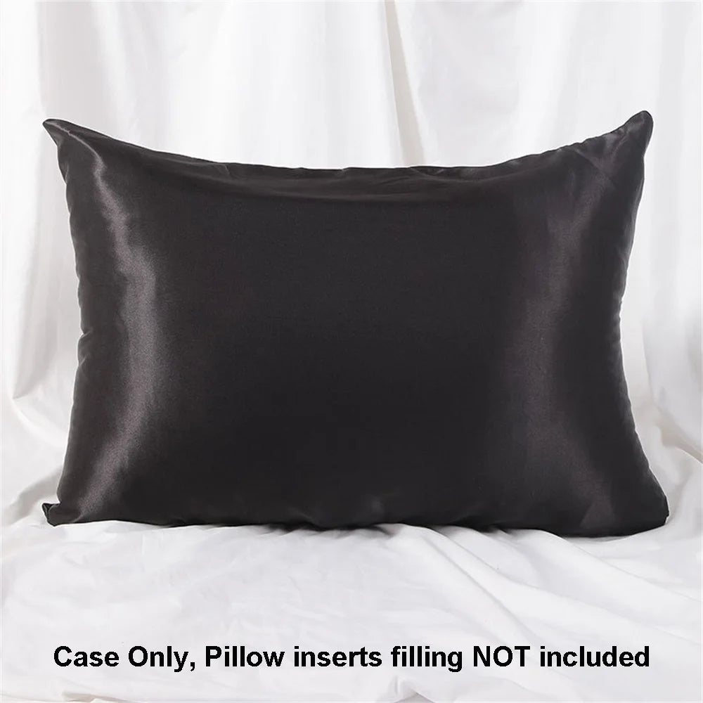 A black satin pillowcase is shown lying flat, ready for use.