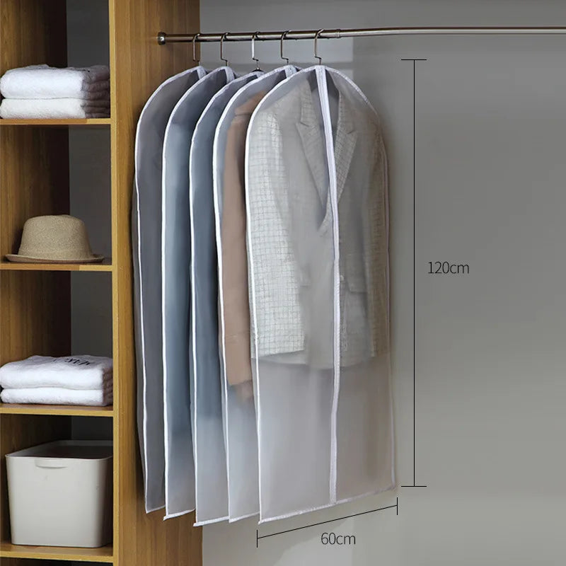 A transparent zippered clothes storage bag hanging on a rod in a wooden cabinet with measurement lines.