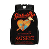 Black canvas backpack featuring a graphic design with a heart and a hammer, and the name Katseye.