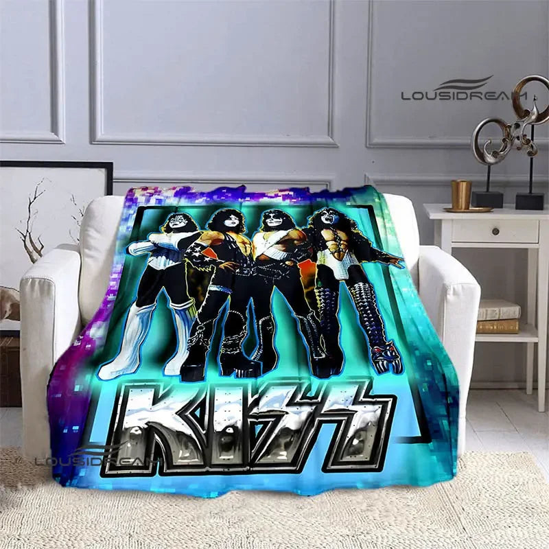 A printed flannel travel blanket featuring a graphic design of a group of stylized figures in dark and bright colors.