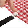 A hand is gripping a red and white checkered fabric with an attached black elastic strap and metal clip.
