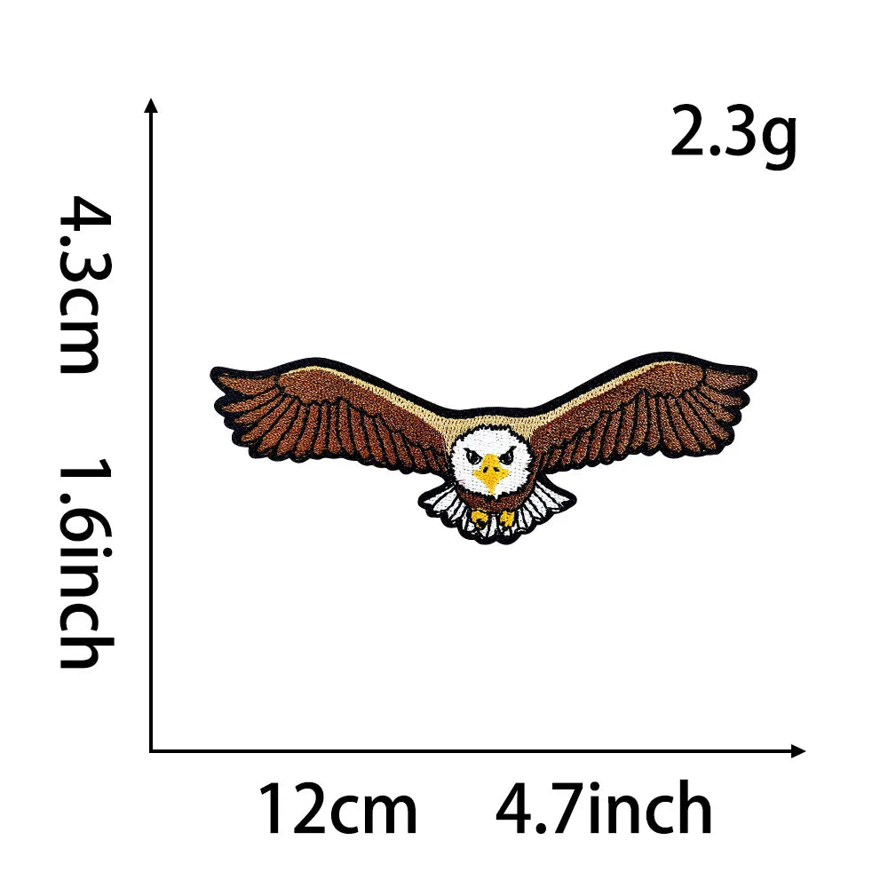 An embroidery patch of an owl with outstretched wings, featuring brown and white colors.