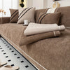 A luxurious brown chenille sofa protector cover with striped pillows and a matching floor accent.
