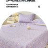 A purple floral quilted bedspread with pink and white flowers is displayed on a bed.