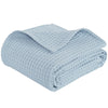 Light blue waffle textured blanket folded and draped