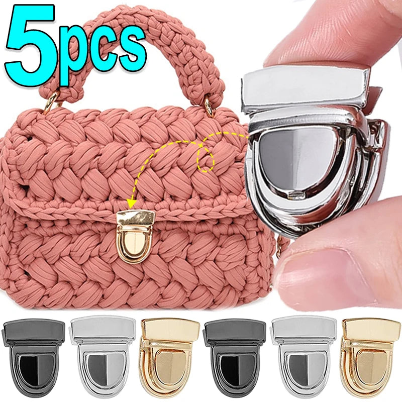 A set of five silver and gold metal bag lock clasps for handbags and totes shown next to a pink crocheted bag.
