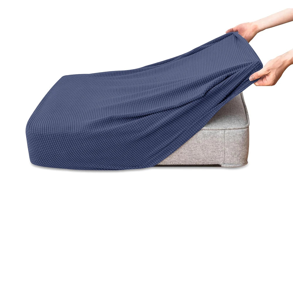 A dark blue polar fleece jacquard sofa seat cushion cover being held by a hand.