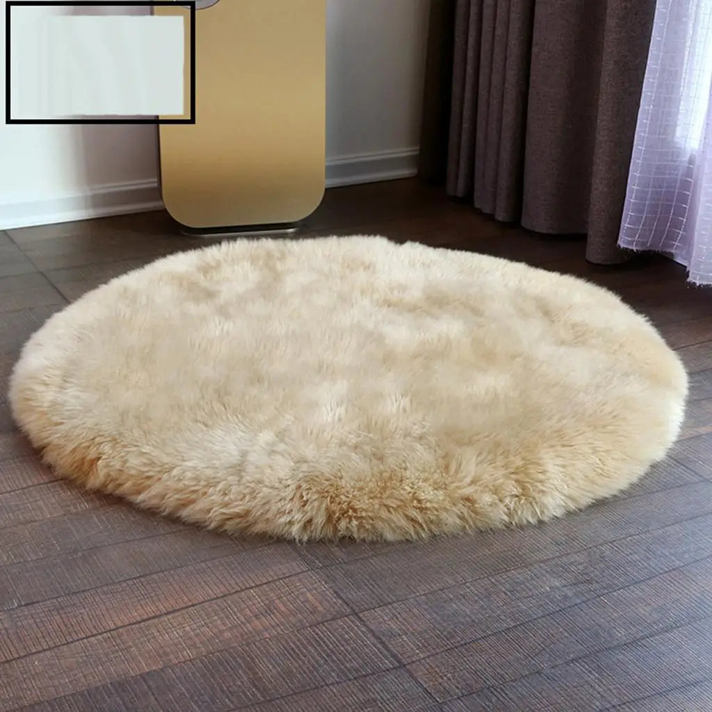 A round, light beige faux fur sheepskin area rug placed on a dark wood floor.