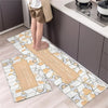 A set of two diamond print non-slip waterproof kitchen rugs placed on a light wood floor next to dark cabinetry.