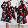 A woman models a red and black patchwork fleece hoodie featuring skull designs.
