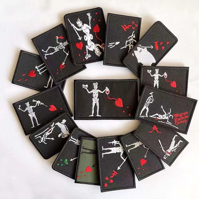 A collection of black embroidered pirate patches featuring skull, flag, and weapon designs with hook and loop backing.