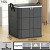 A dark gray foldable storage bag with a lid is shown standing on a wooden floor.