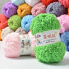 A pile of colorful soft coral velvet yarn balls in various shades of pink, purple, green, and yellow.