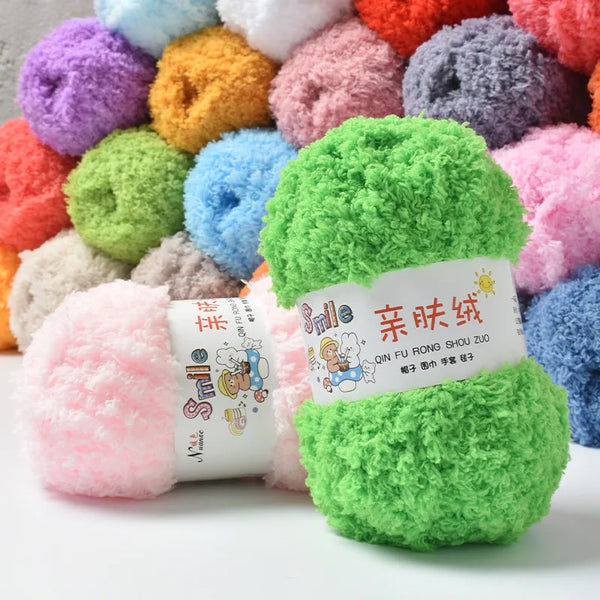 A pile of colorful soft coral velvet yarn balls in various shades of pink, purple, green, and yellow.