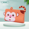 An orange monkey shaped memory foam neck pillow for toddlers sitting on a white surface.