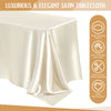 A smooth, cream-colored satin tablecloth draped elegantly on a table.