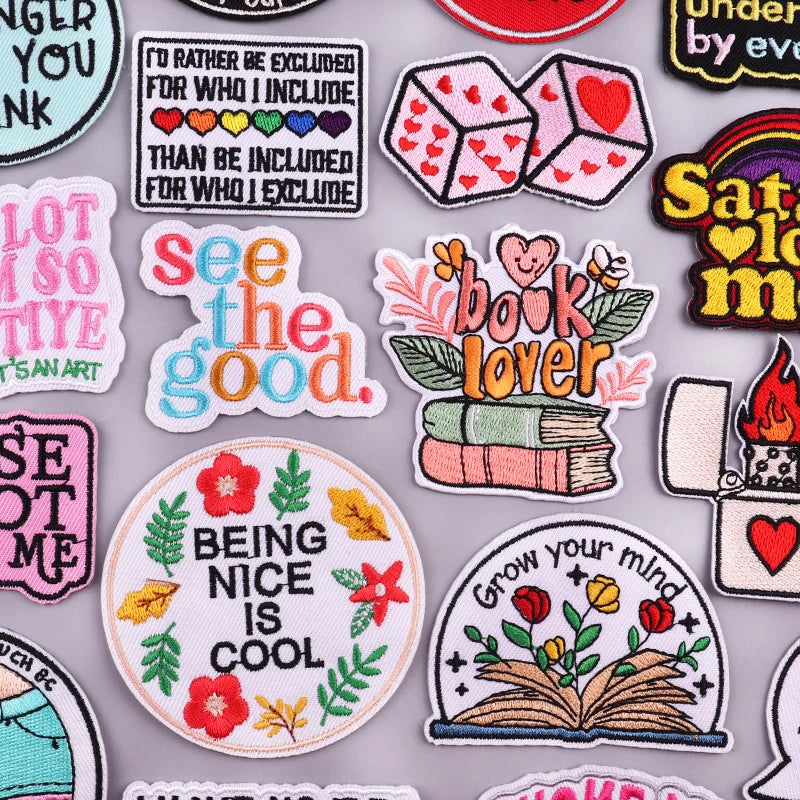 A collection of embroidered letter iron-on patches featuring various inspirational and cute designs.