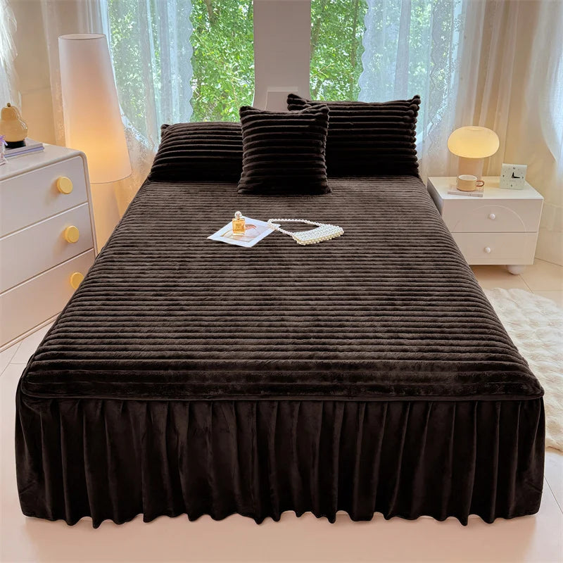 A dark brown plush bed skirt linen set is displayed on a bed, with natural light filtering through sheer curtains.