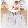 A baby is sitting on a white play mat with various toy cars and accessories.